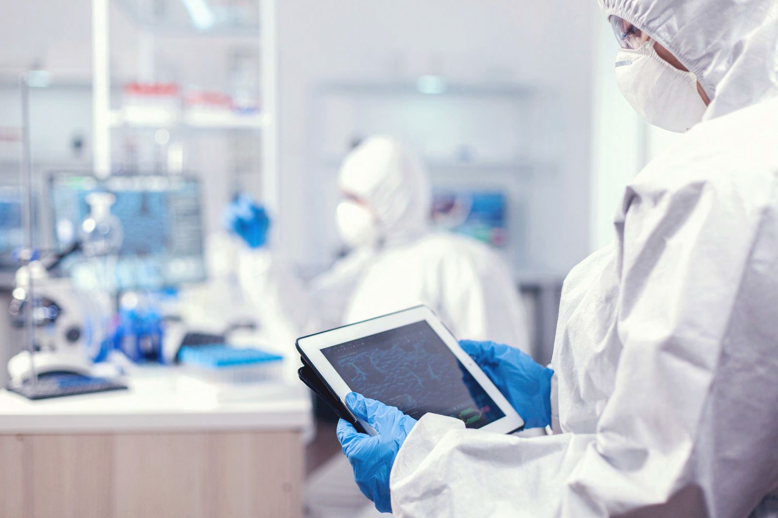 Clinical researcher reviewing a personalized medical scan on a tablet